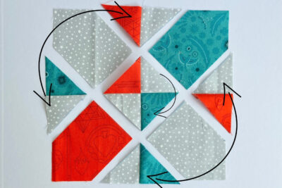 aqua, blue, & orange quilt blocks on white table