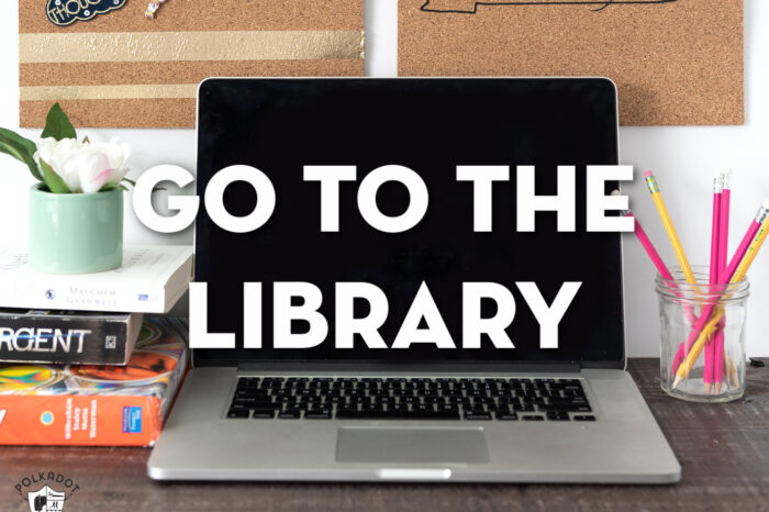 Image of computer on desk with books and pencils