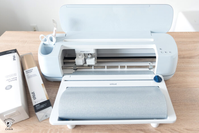 new cricut maker 3 machine on wood table in front of white wall