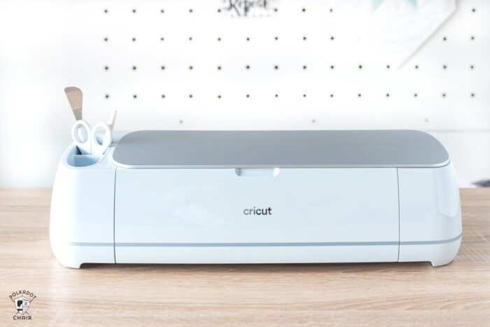 new cricut maker 3 machine on wood table in front of white wall