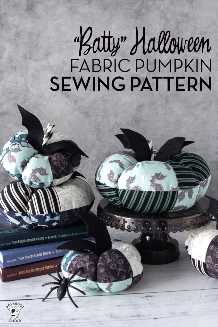 Stack of blue and gray fabric pumpkins in front of gray wall.