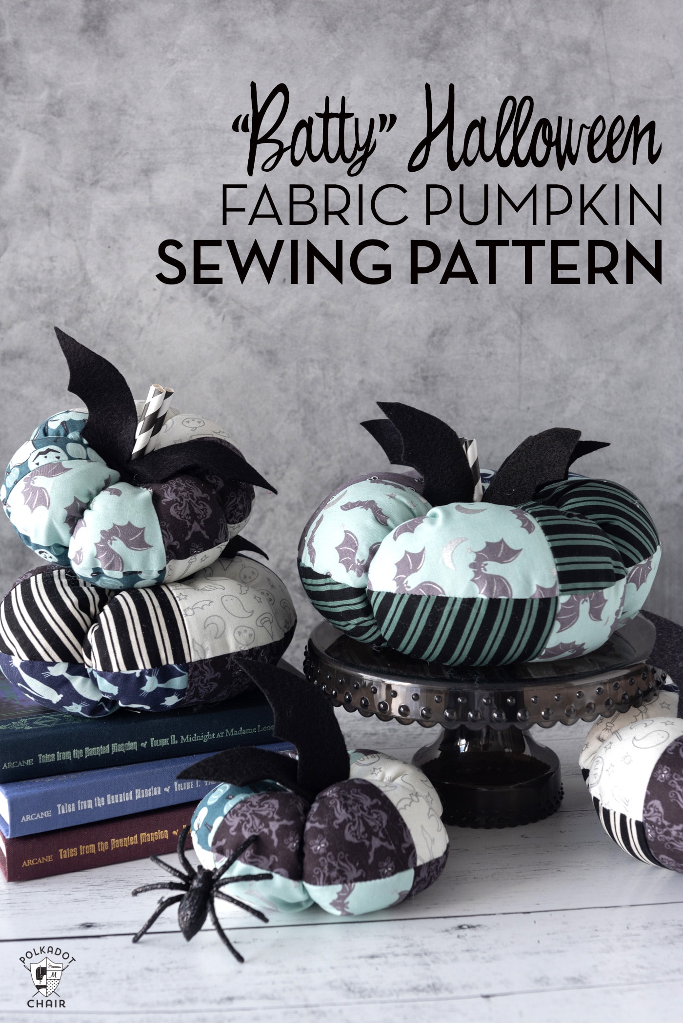 stack of fabric pumpkins on white table with gray background