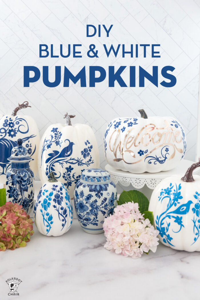 a collection of blue and white pumpkins on a white counter top with flowers