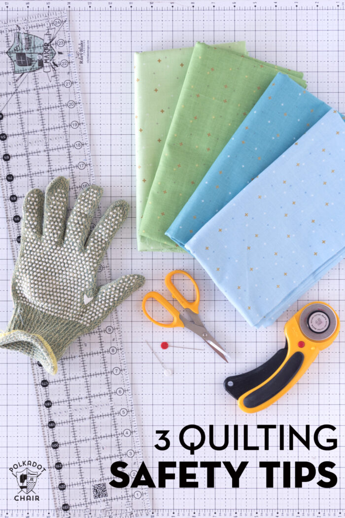 hand with cut glove on white cutting mat with quilt ruler and rotary cutter