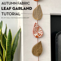 fabric leaves hanging from fireplace mantel decorated for autumn