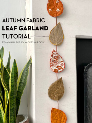 fabric leaves hanging from fireplace mantel decorated for autumn