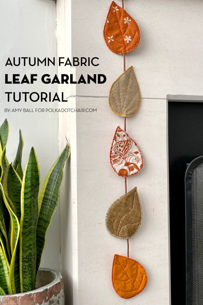 fabric leaves hanging from fireplace mantel decorated for autumn
