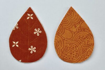 red and orange fabric leaves on white table
