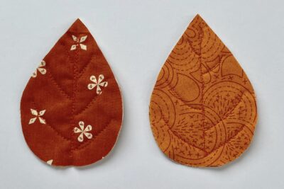 red and orange fabric leaves on white table