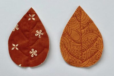 red and orange fabric leaves on white table