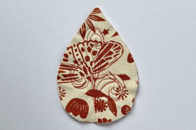 red and white fabric leaf on white table