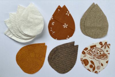 fabric leaves and quilt batting on white table