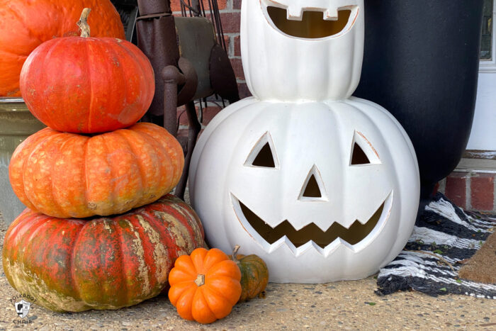 white pumpkin next to stack of heirloom pumpkins