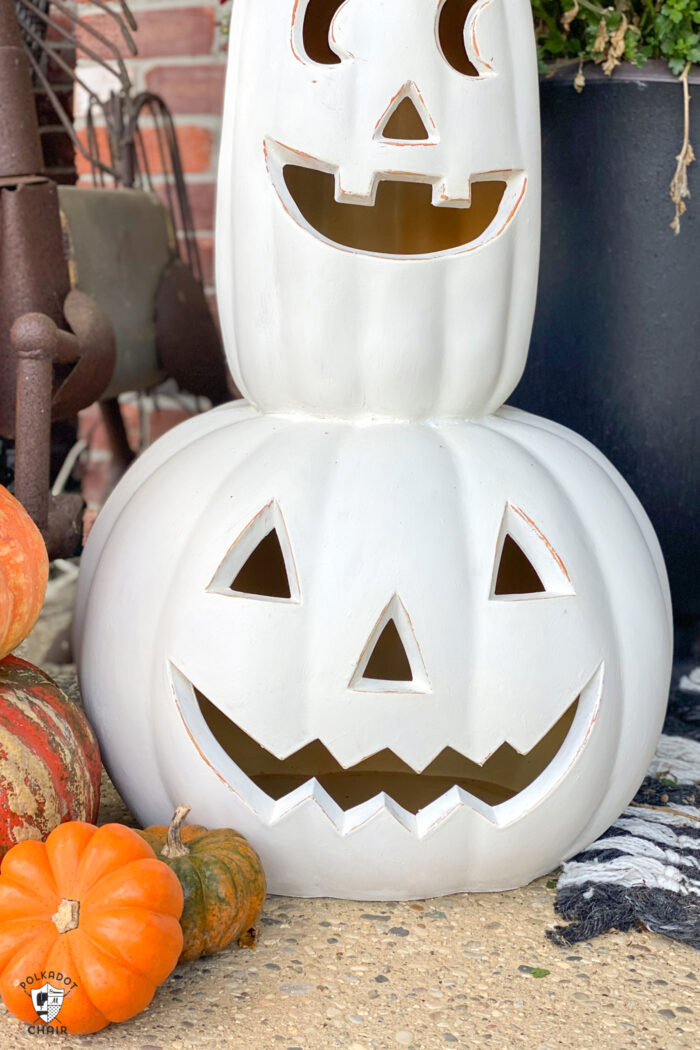 two white pumpkins painted and stacked