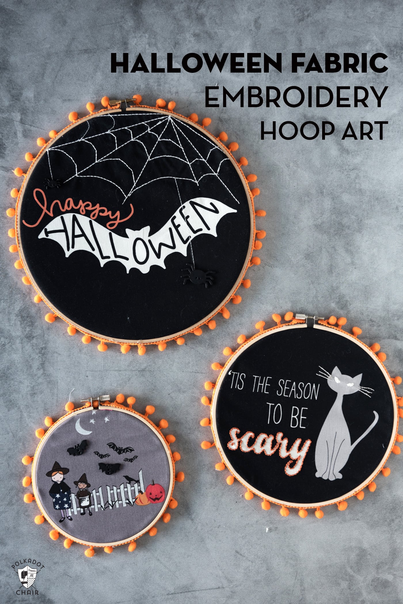 3 black fabric embroidery hoops on gray table with orange pom pom trim