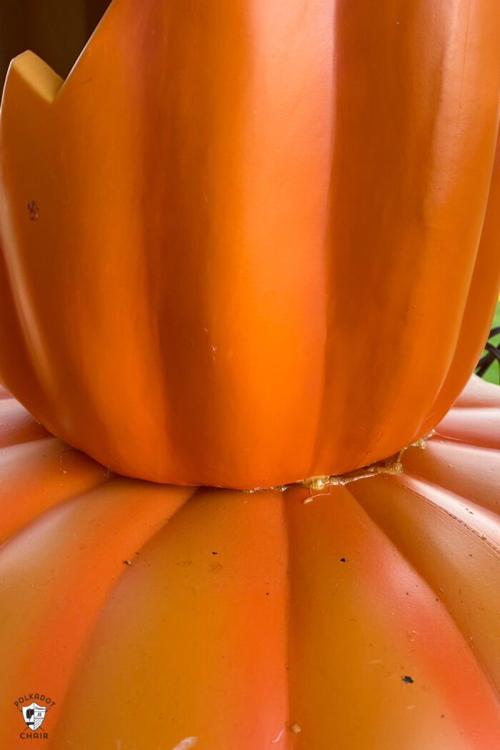 close up of glue inbetween plastic pumpkins