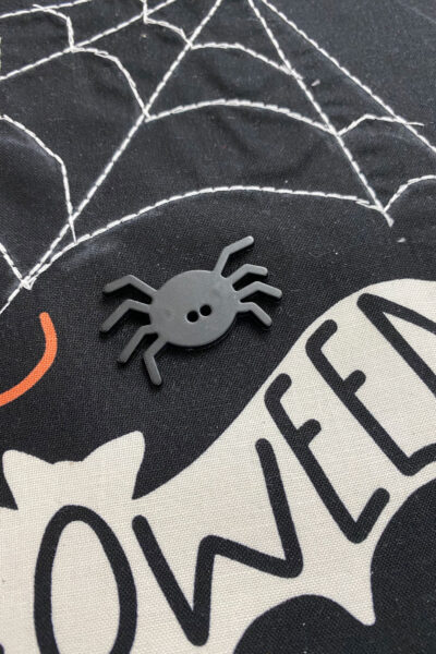 close up of spider button on halloween fabric