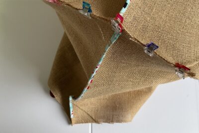 long strip of fabric folded in half and pinned to burlap