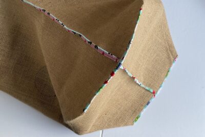 long strip of fabric folded in half and pinned to burlap