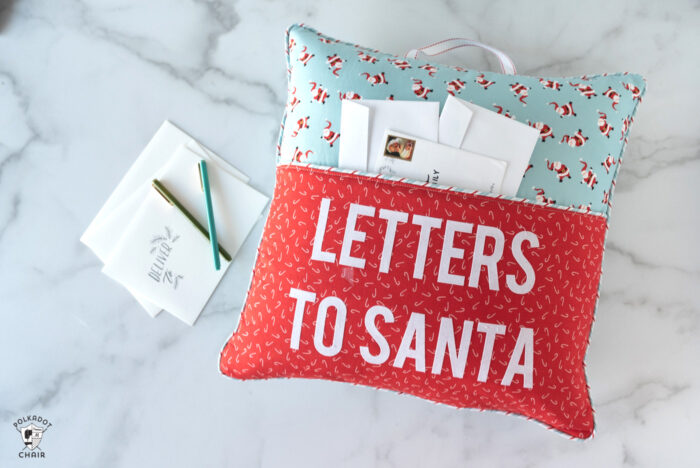 red and turquoise reading pillow on white background with "letters to santa" lettering on front