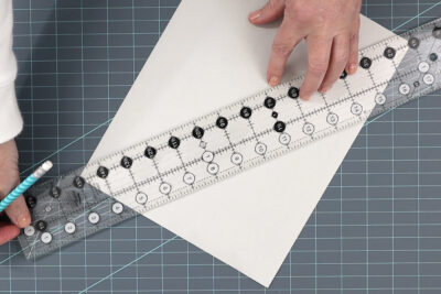 ruler and paper on blue cutting mat