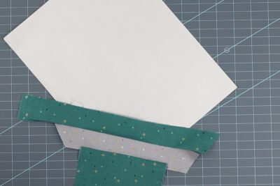green and gray fabrics sewn to paper