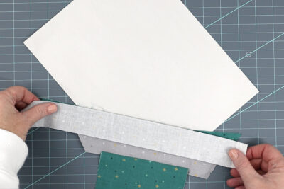green and gray fabrics sewn to paper