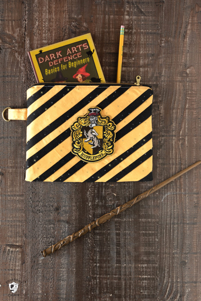 striped zip pouches on wood table with wand
