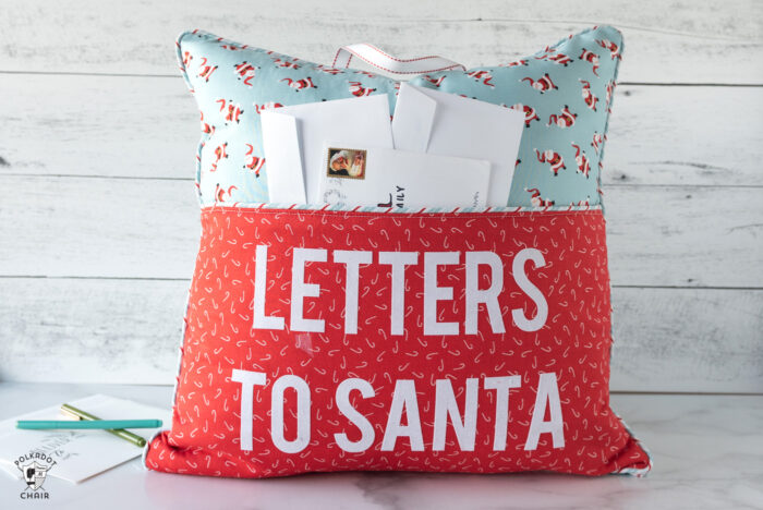red and turquoise reading pillow on white background with "letters to santa" lettering on front