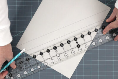 ruler and paper on blue cutting mat