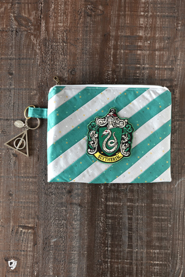 striped zip pouches on wood table with wand & keyring