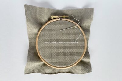 white stitching on tan embroidery fabric