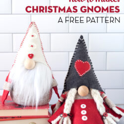 Red & gray stuffed Christmas gnomes on white countertop with books