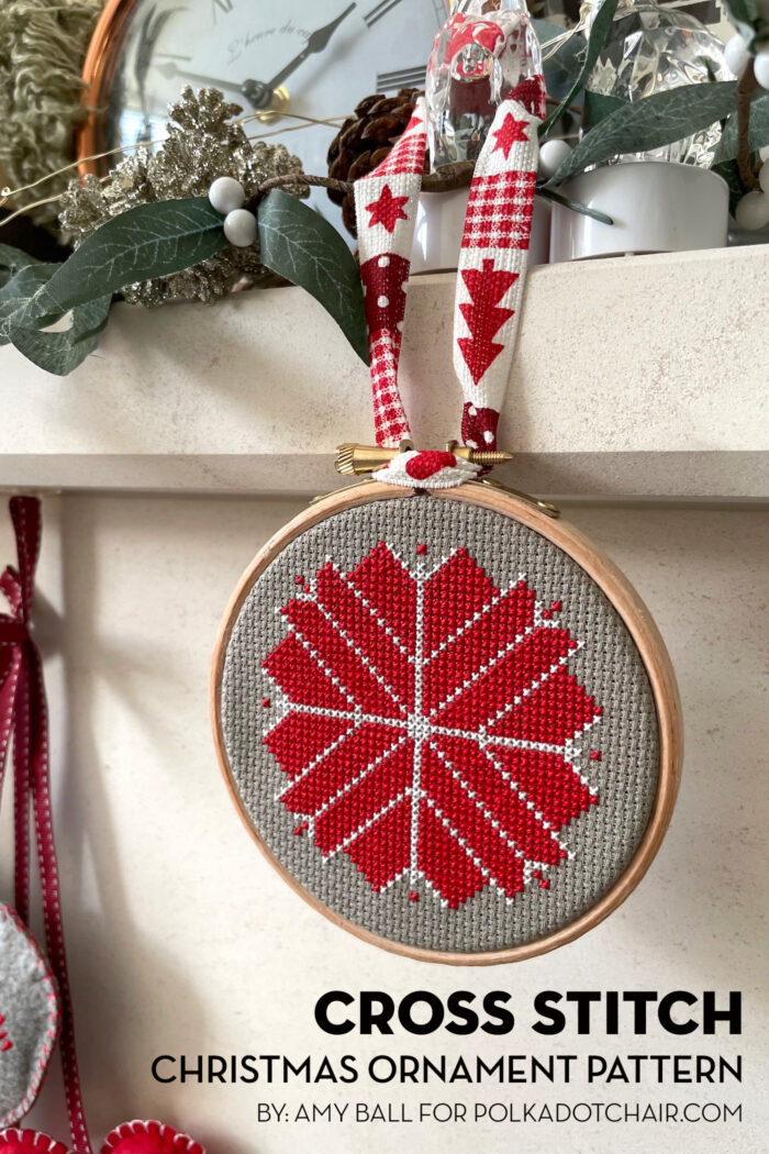 red, white and gray christmas ornament hanging on fireplace mantle