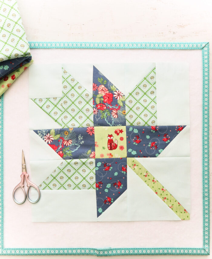 blue and green quilt block with scissors on table