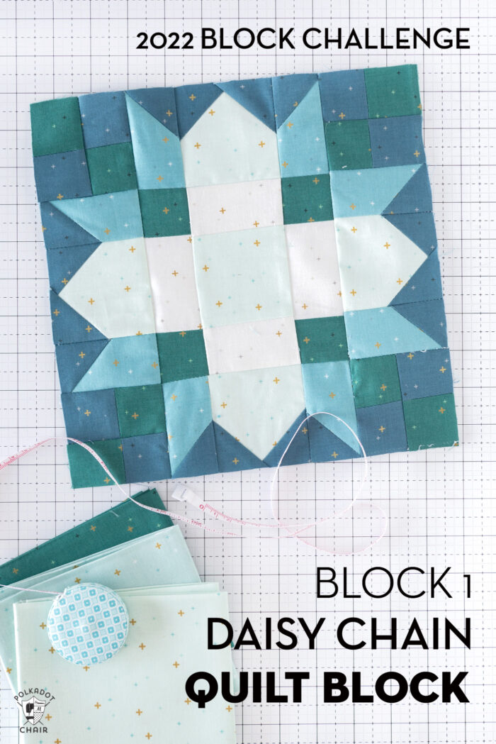 White blue and green quilt block on white cutting mat with folded fabrics