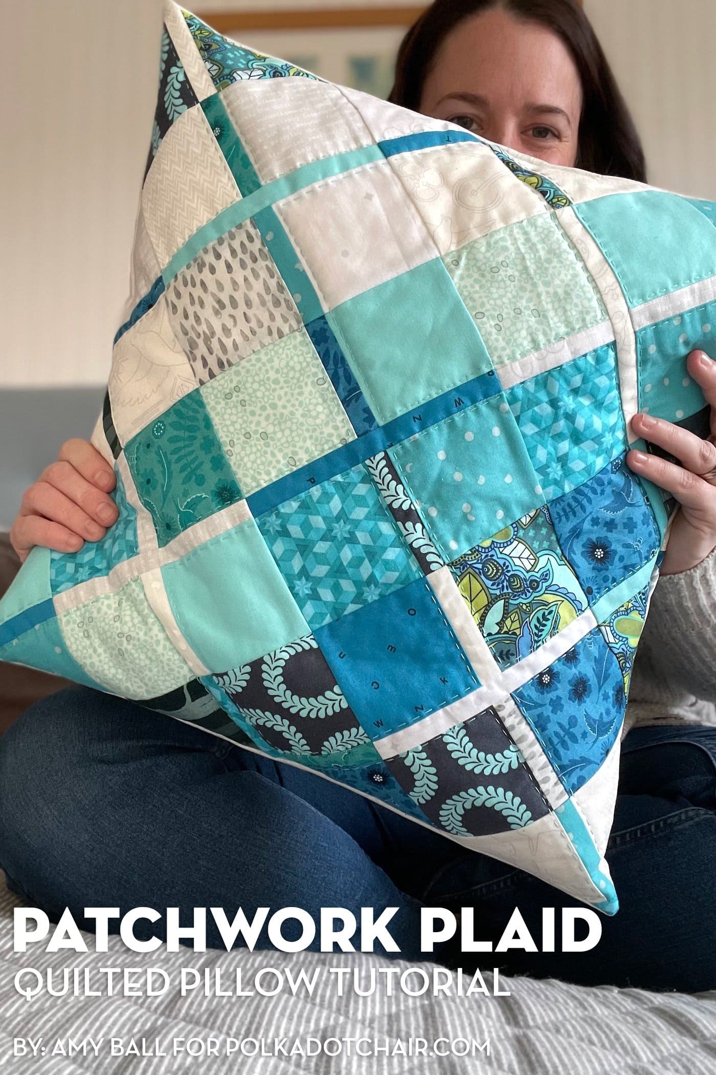 woman holding blue plaid quilted pillow