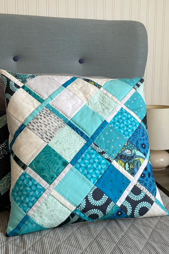 blue quilted pillow on gray chair