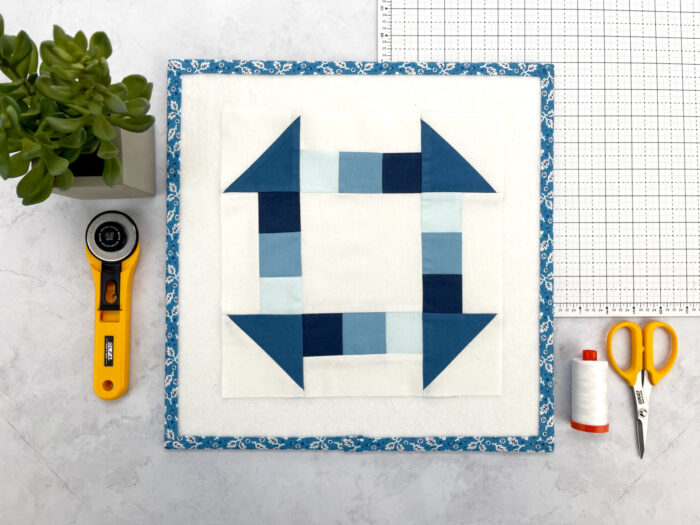 blue and white quilt block on cutting mat