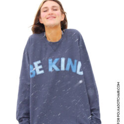 girl wearing blue sweatshirt standing in snowstorm