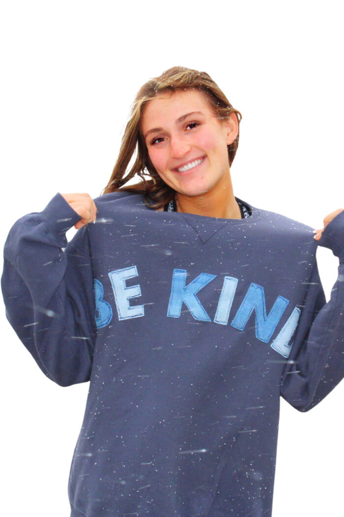 girl wearing blue sweatshirt standing in snowstorm