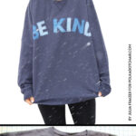 girl wearing blue sweatshirt standing in snowstorm