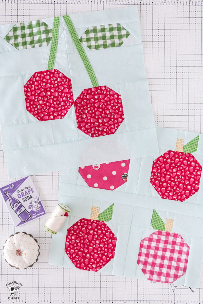 cherry and apple quilt blocks on white cutting mat