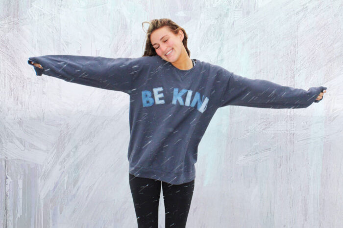 girl wearing blue sweatshirt standing in snowstorm