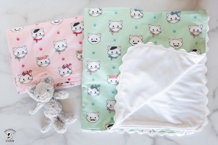 pink and mint flannel blankets on white table top with small toy cat
