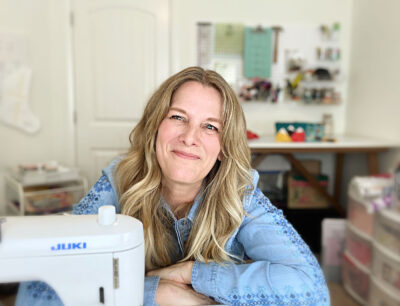woman sitting at sewing machine