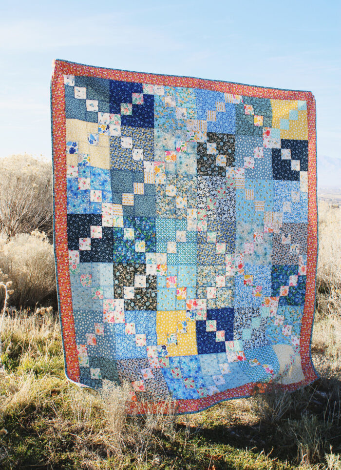blue and yellow patchwork quilt outdoors