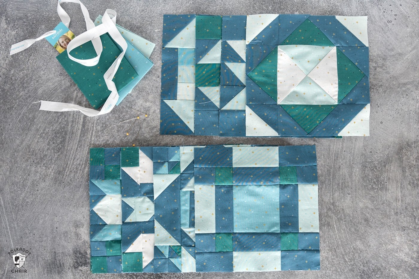 photo of several blue and aqua quilt blocks on gray metal table