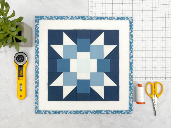 blue and white quilt block on white cutting mat