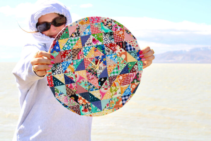 woman holding patchwork clock outdoors
